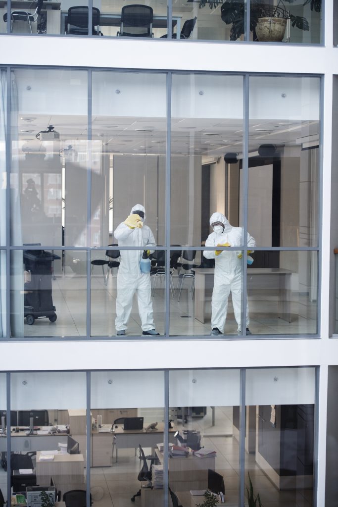 full-shot-people-hazmat-suit-cleaning-office